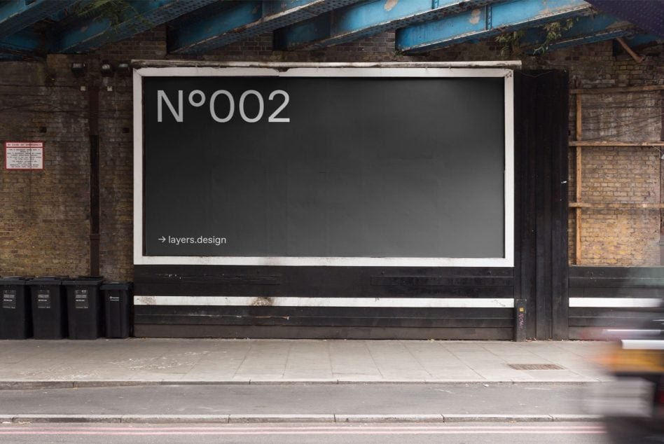 Storefront mockup with large black billboard on weathered brick building displaying N°002 branding