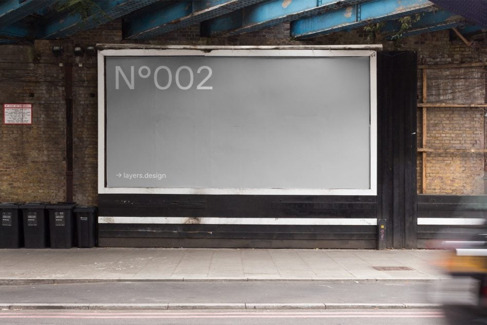 White framed storefront display N°002 on industrial brick building with weathered facade