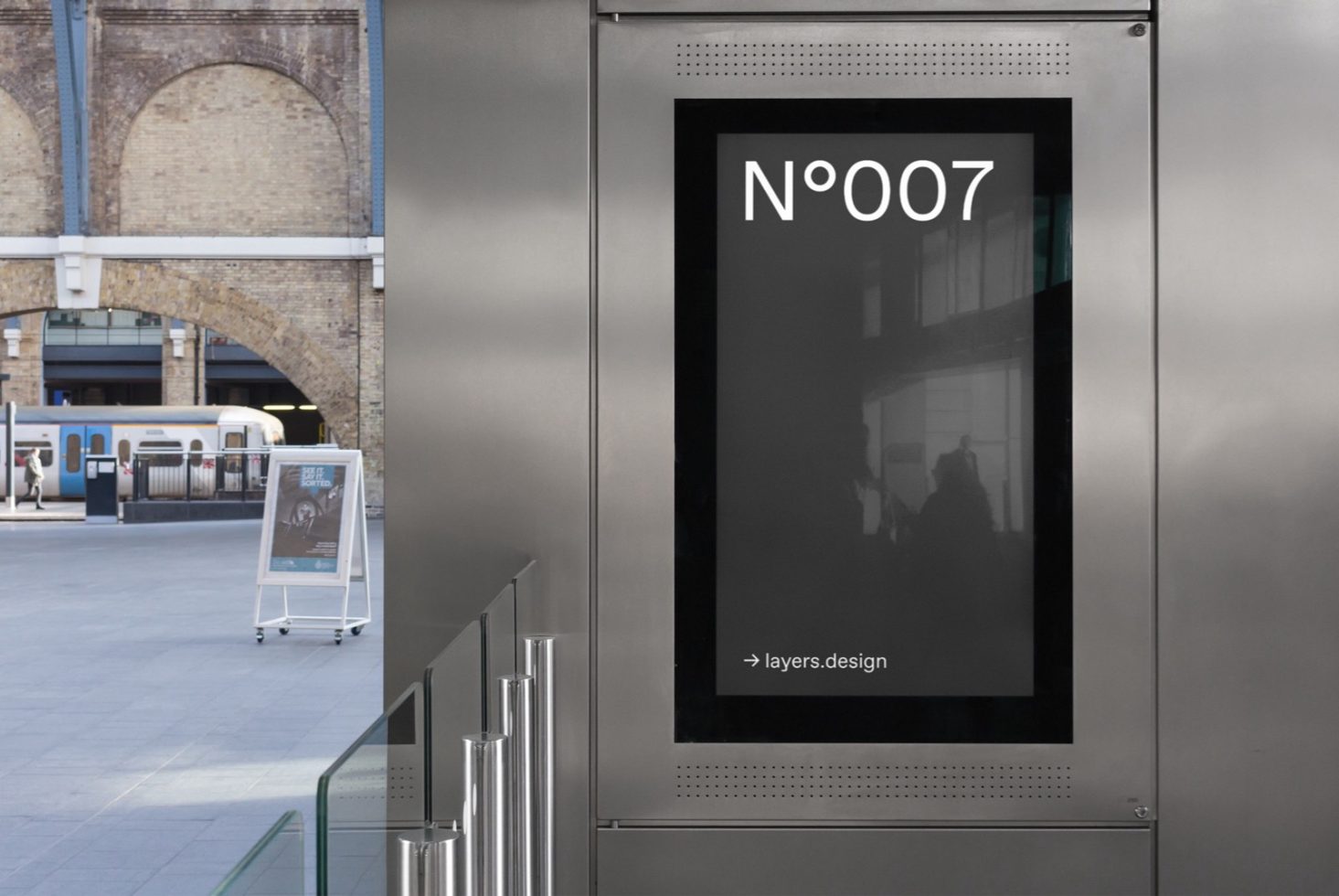 Outdoor poster mockup on digital display at train station platform with urban backdrop, ideal for designers, advertising editable template.