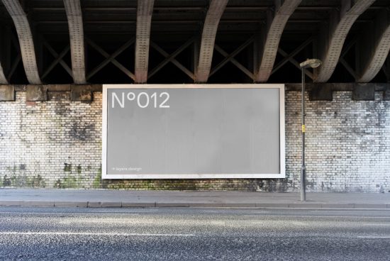 Urban billboard mockup under bridge for advertising design presentation, empty large format banner, brick wall texture, realistic street setting.