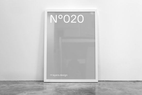 Minimalist poster mockup in frame leaning against white wall with reflective surface for print design display.