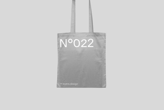 Minimalist tote bag mockup in grayscale with typographic design, ideal for showcasing branding and packaging designs for designers.