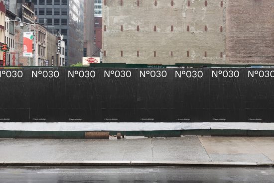 Urban scene with repetitive text mockup on a construction barricade for graphic design display, showcasing modern font style and city context.
