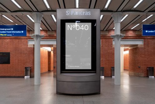 Digital advertising billboard mockup at St Pancras station, ideal for showcasing design projects and graphics in a realistic urban setting.