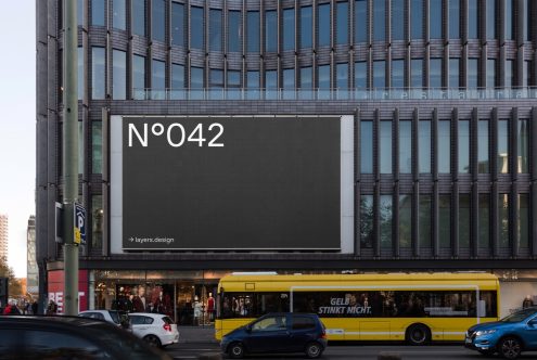 Urban billboard mockup on building exterior for advertising design presentation, with clear sky and street view, realistic city environment.