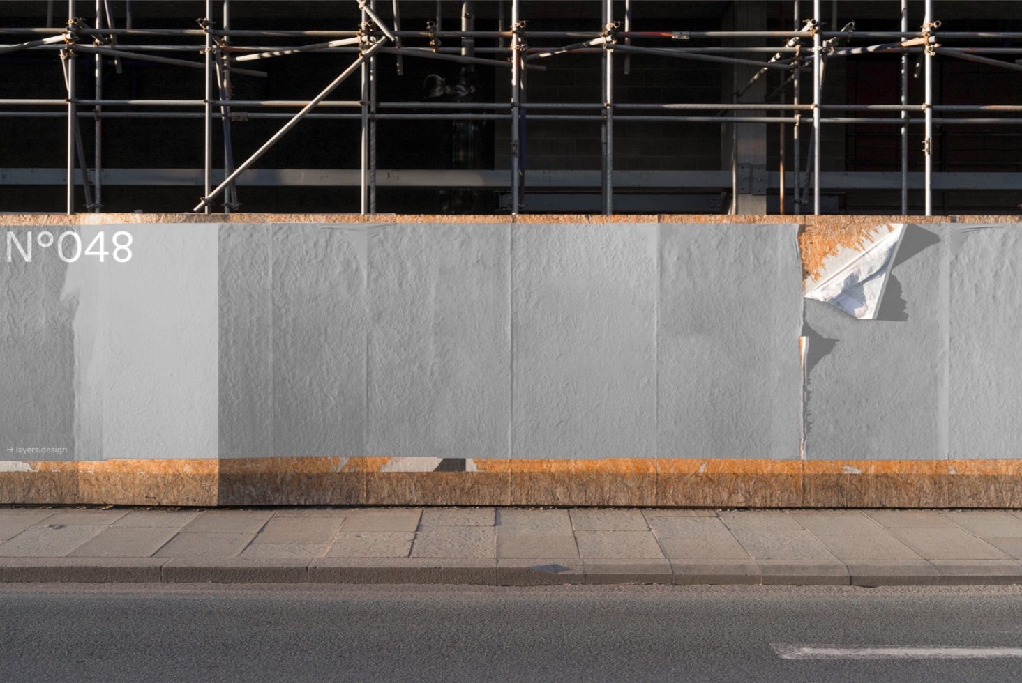 Urban construction wall with scaffolding and torn poster, ideal for mockup background, designers, realistic textures.