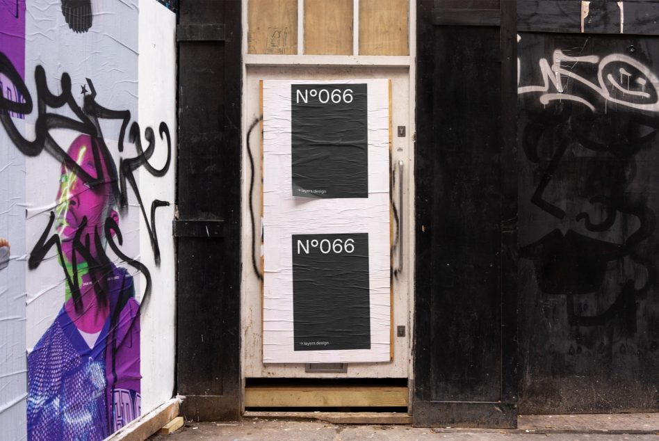 Storefront door mockup with two stacked posters on white brick between graffitied walls