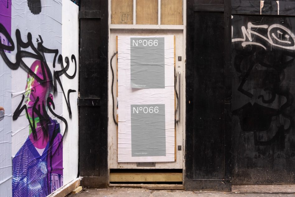 White door with two gray posters both labeled N°066 surrounded by graffiti