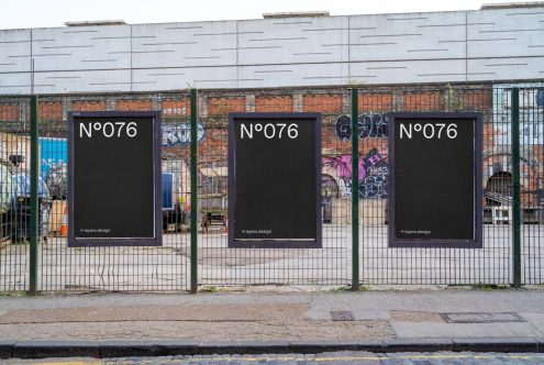 Urban street poster mockups on a metal fence for advertising, with graffiti background. Ideal for designers to showcase billboard designs.