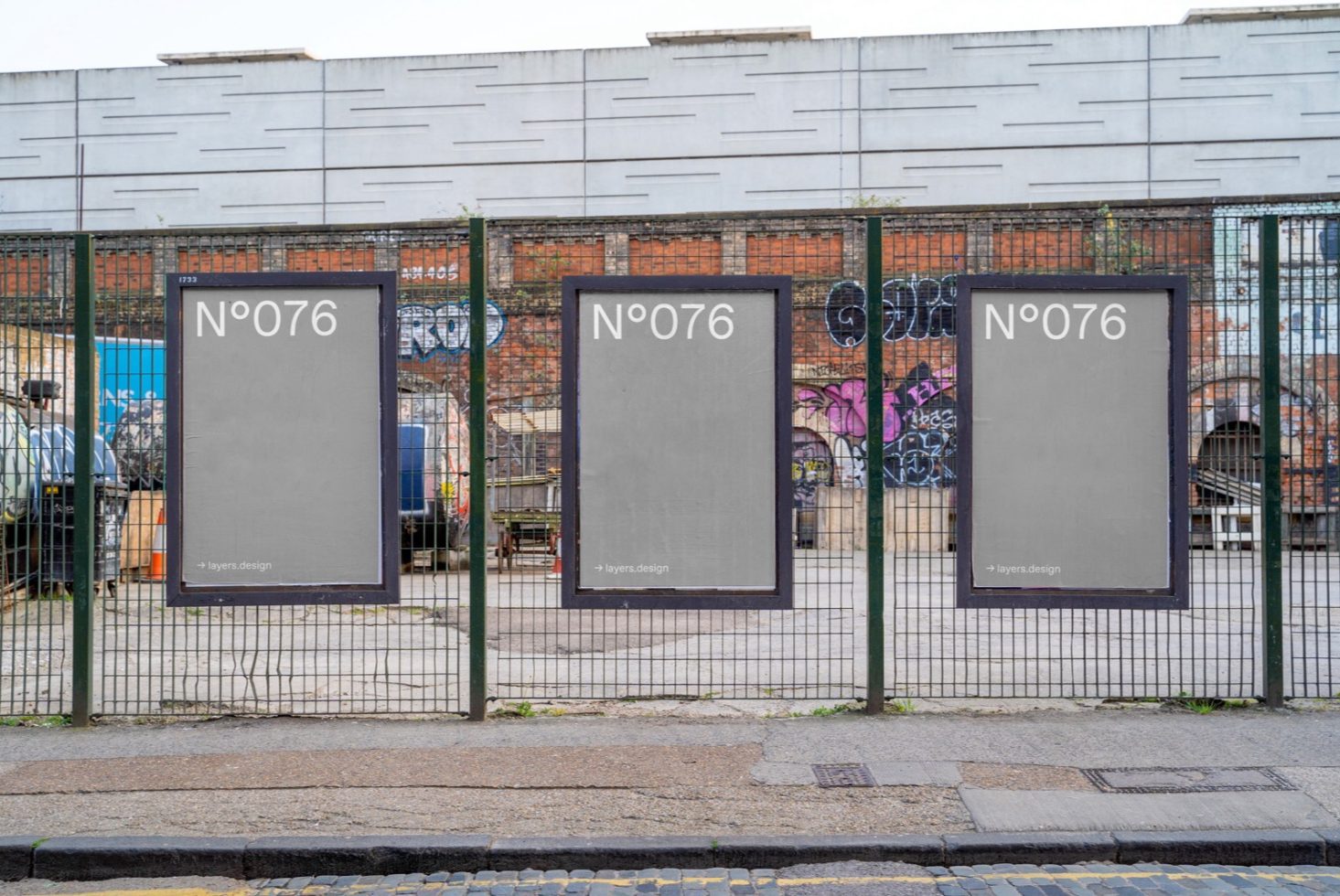 Urban outdoor poster mockup series on a metal fence with an industrial backdrop, perfect for graphic designers to showcase advertisements.