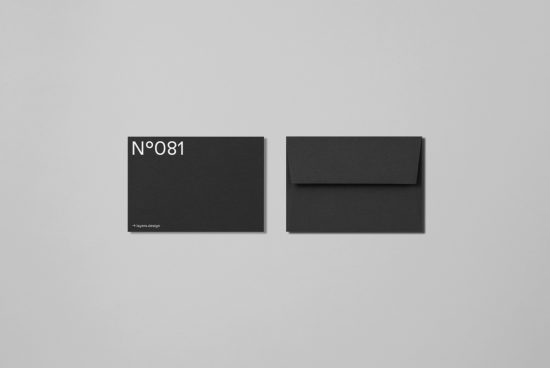 Black envelope mockup with designer card on a grey background, minimalistic stationery design template for branding identity.