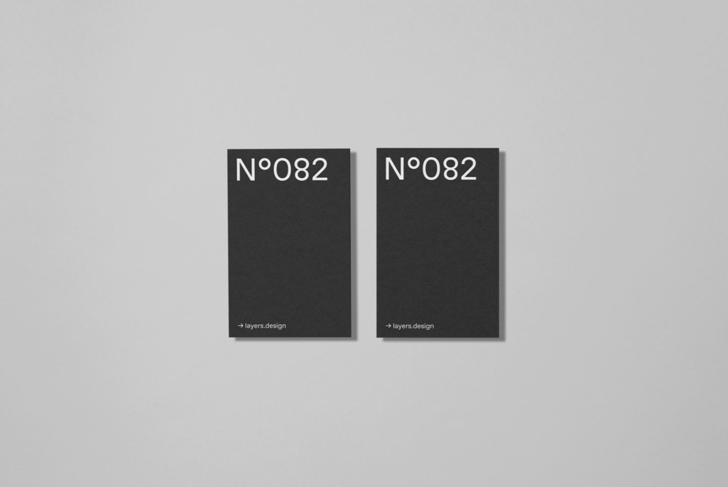 Two minimalistic black book cover mockups with white typography on a gray background, perfect for showcasing publication design.