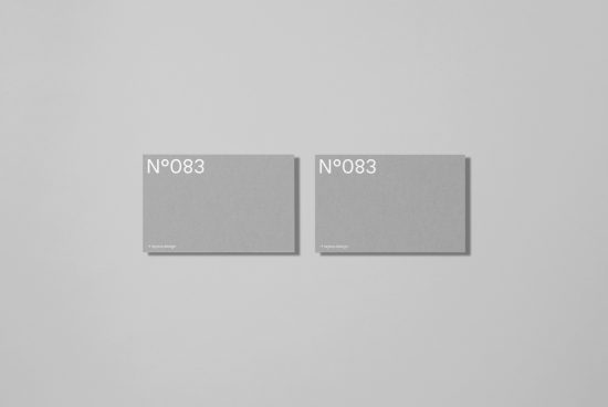 Two minimalist business card mockups in gray with stylish typography, ideal for modern branding presentations and graphic design.