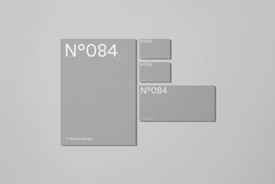 Minimalist stationery mockup with assorted gray cards and envelopes on a plain background, for presentation and design showcase.