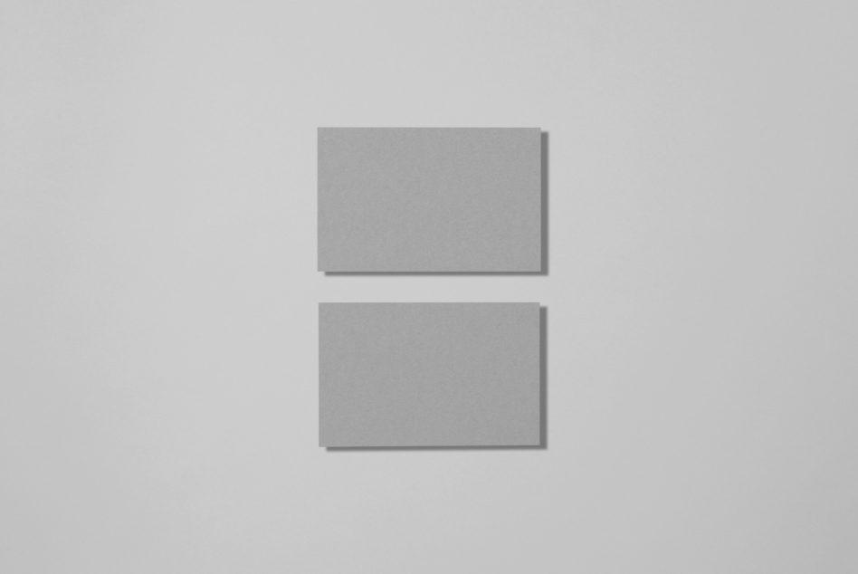 Two blank square paper mockups on a plain gray background, clean design, minimal shadow, ideal for branding presentations.