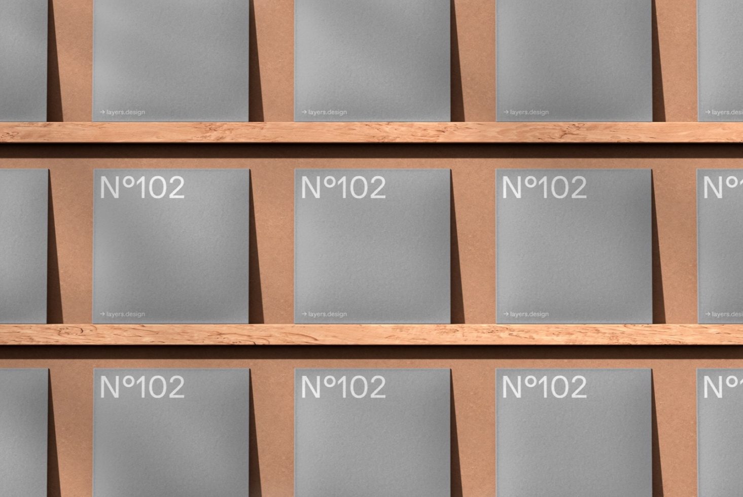 Wooden bookshelf with evenly spaced gray mockup books labeled N°102 for design template display.