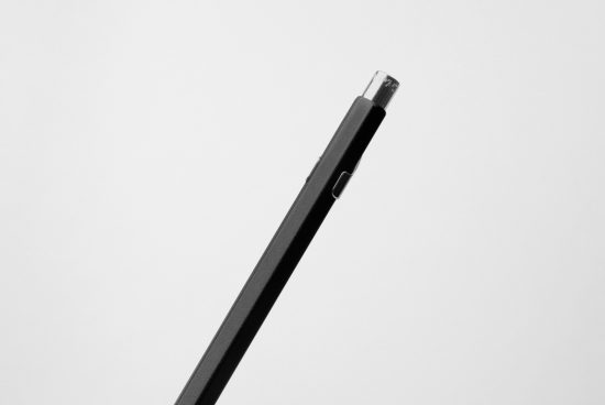 Side view of a sleek black stylus pen on a white background, isolated for use in graphics design mockups and digital art templates.