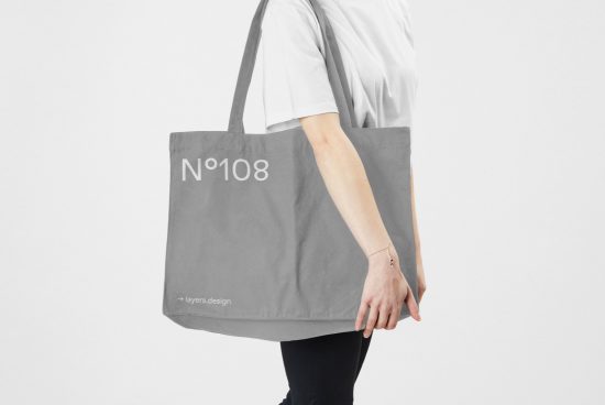 Person holding tote bag mockup, minimalist design, side view, for showcasing branding and patterns, ideal for graphic designers.