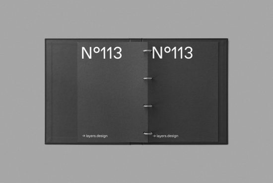 Open black folder mockup with metal rings and white text on a gray background, ideal for presenting design projects, branding, and portfolio pieces.