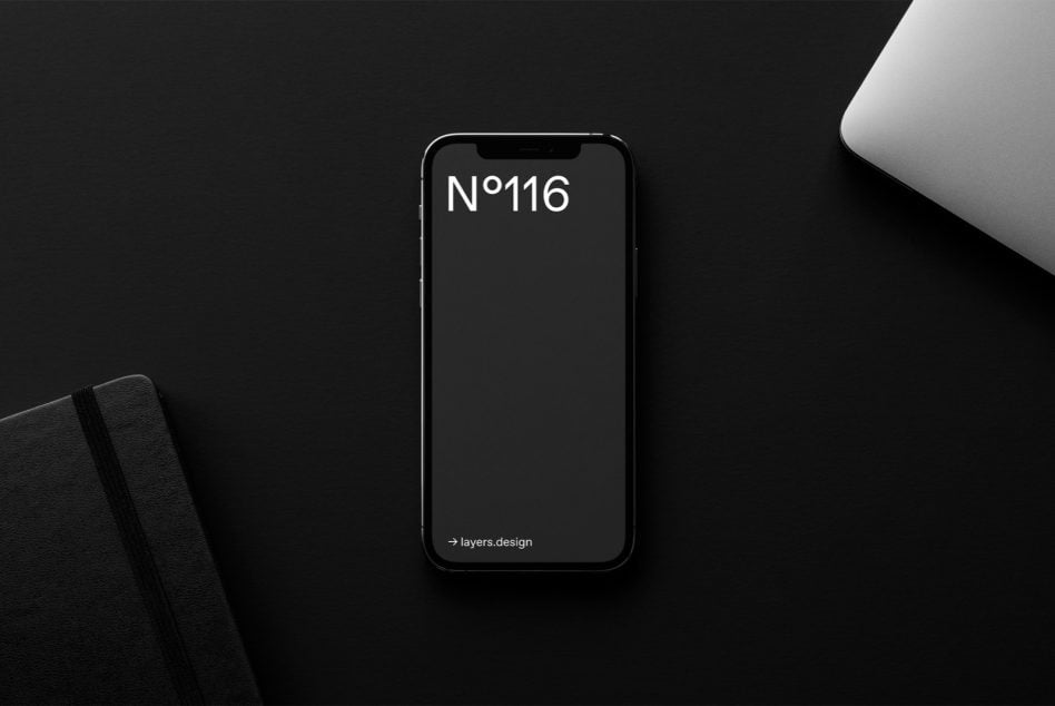 Dark iPhone displaying N°116 on minimalist black studio setup