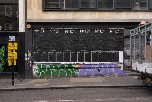 Urban street wall with graffiti and posters, textured surface, ideal for mockup backgrounds, urban design elements, realistic setting for visual presentations.