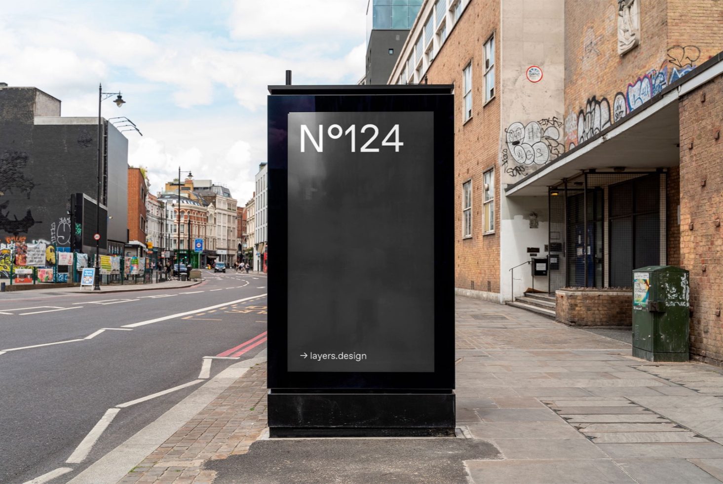 Urban street billboard mockup in cityscape for designers to display advertising graphics and posters, clear sky, daytime setting.