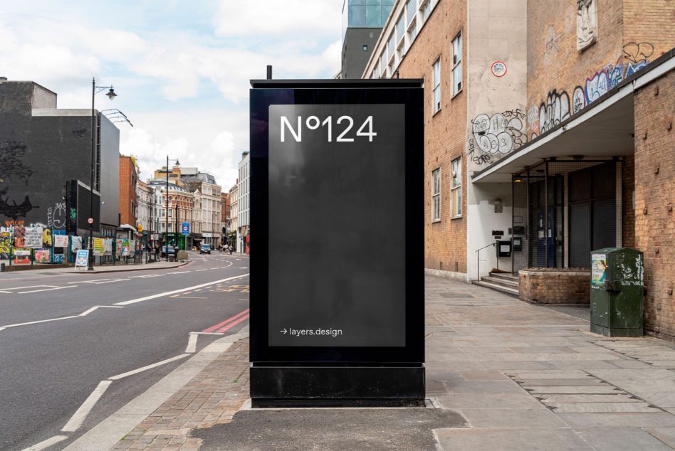 Urban street billboard mockup in cityscape for designers to display advertising graphics and posters, clear sky, daytime setting.