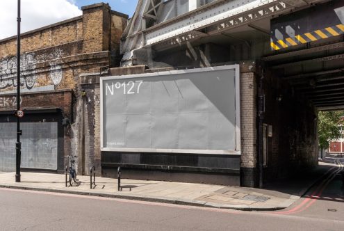 Urban billboard mockup under a bridge for outdoor advertising design presentations, with textures and street elements for realistic scene setting.