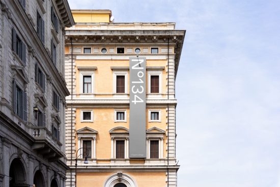 Architectural mockup of a classical building with a modern vertical banner design for urban branding.