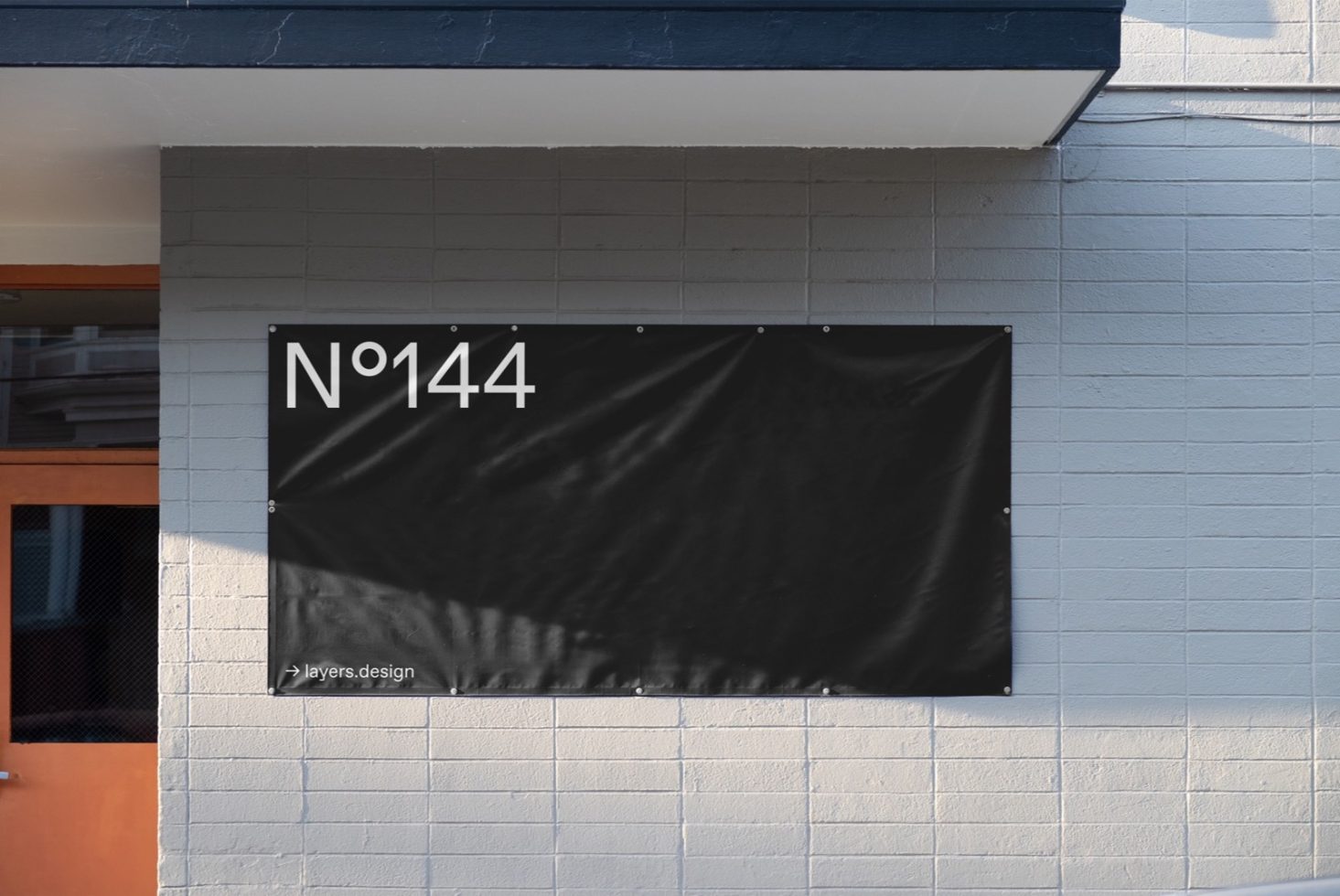 Urban wall-mounted banner mockup with minimal typography design, suitable for creating realistic signage presentations in urban settings for designers.