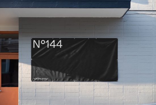 Urban wall-mounted banner mockup with minimal typography design, suitable for creating realistic signage presentations in urban settings for designers.