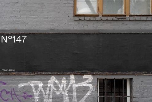 Urban brick wall texture with graffiti and address number for realistic mockup backgrounds, ideal for template designs.