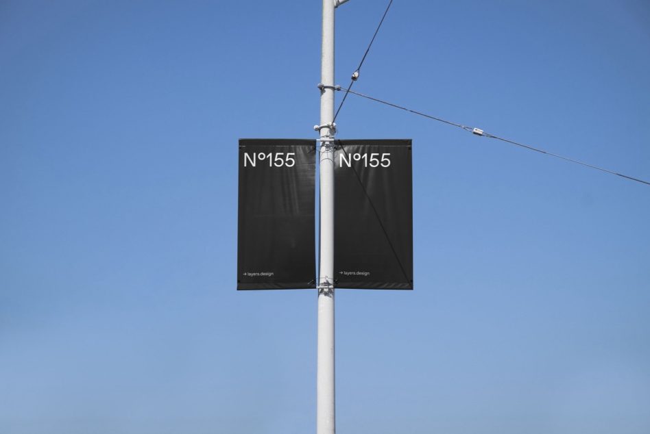 Outdoor banner mockup on a light pole with clear blue sky, showcasing minimalist design for advertising, ideal for designers and templates.