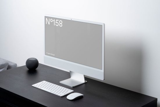 Modern desktop computer mockup on dark table with keyboard and mouse, minimalist workspace design, digital template for presentations.