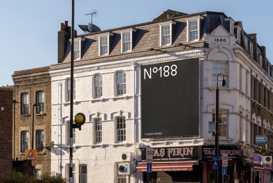 Urban billboard mockup on a classic building dated 1880, clear sky, designers can showcase ads, posters, or graphics with a realistic look.