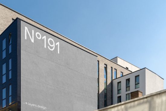 Modern urban building facade with minimalist number design, clear sky backdrop, suitable for mockup and graphic design elements.