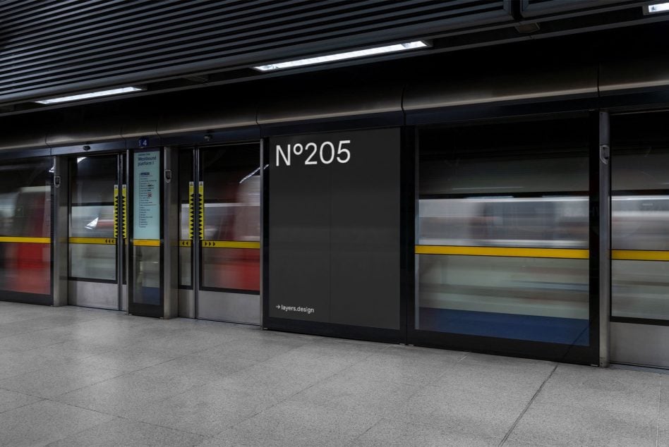 Underground station billboard beside double doors with dark background, N°205