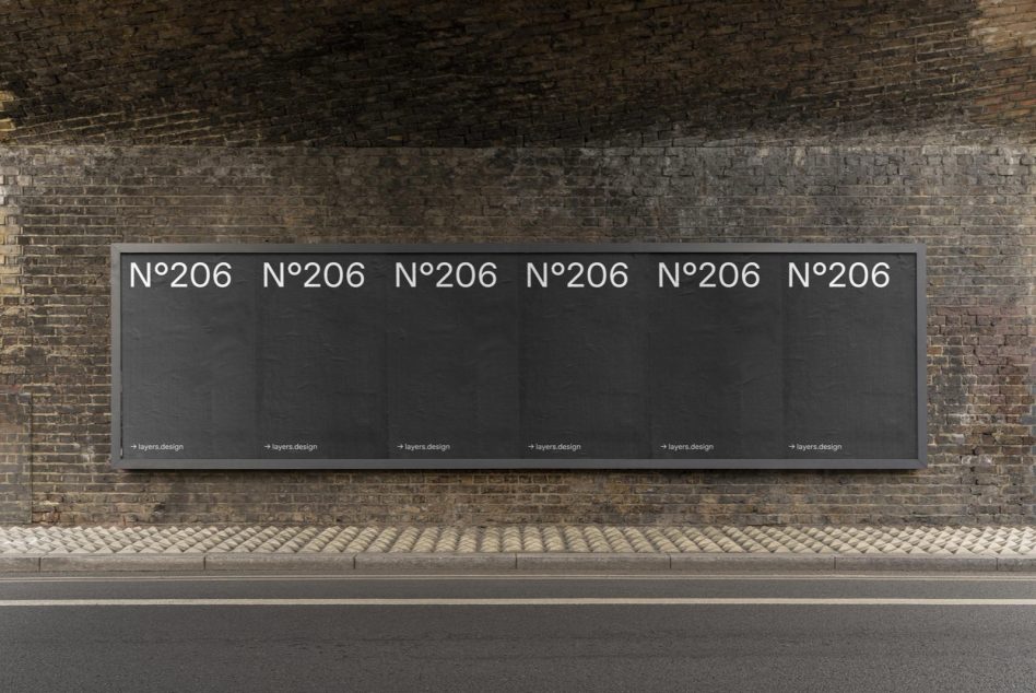 Horizontal street-level billboard on aged brick wall with dark background, N°206