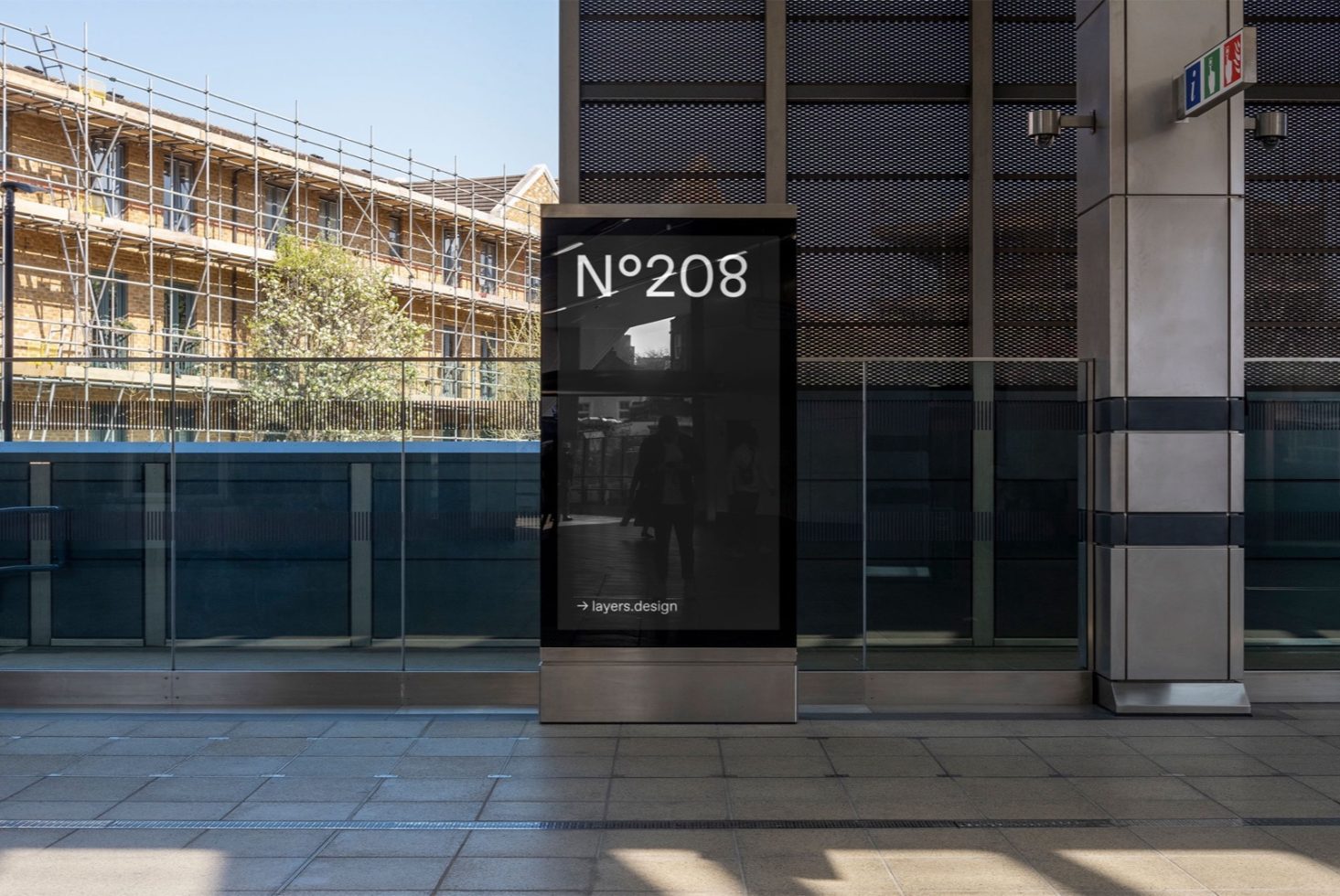 Urban digital billboard mockup for outdoor advertising in a contemporary street setting with scaffolding and modern architecture.