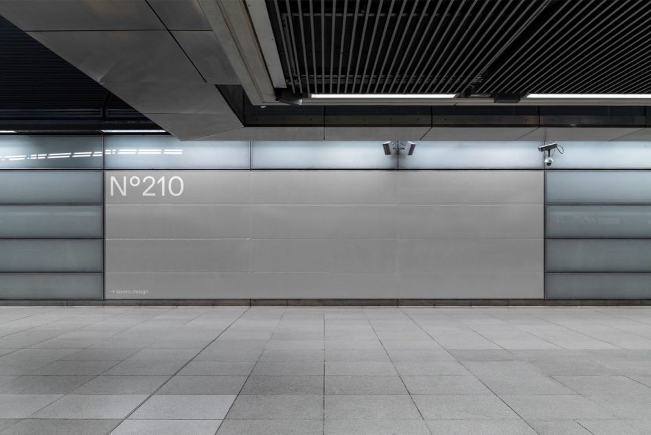 Modern urban subway station wall with sleek metal panel design, tiled floor, and lighting fixtures for architectural mockup.