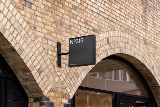 Square shop sign mockup on a brick wall archway exterior, perfect for storefront design presentations and urban signage displays.