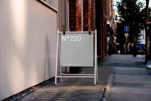 Urban street signage mockup on sidewalk with clear sign ready for branding and design presentation.