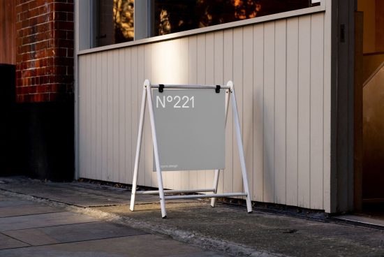 Sidewalk sandwich board mockup with customizable design showcasing address number in urban setting, ideal for designers to display signage graphics.