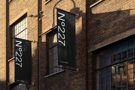 Elegant vertical banner mockup on building exterior with sleek typography for outdoor advertising design assets.