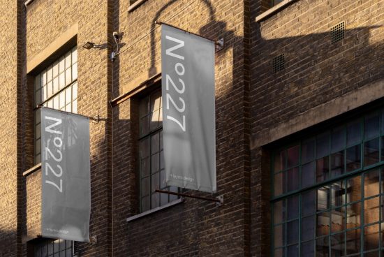 Urban building facade with vertical banners mockup, showcasing street view of realistic signages for brand display in sunlight.