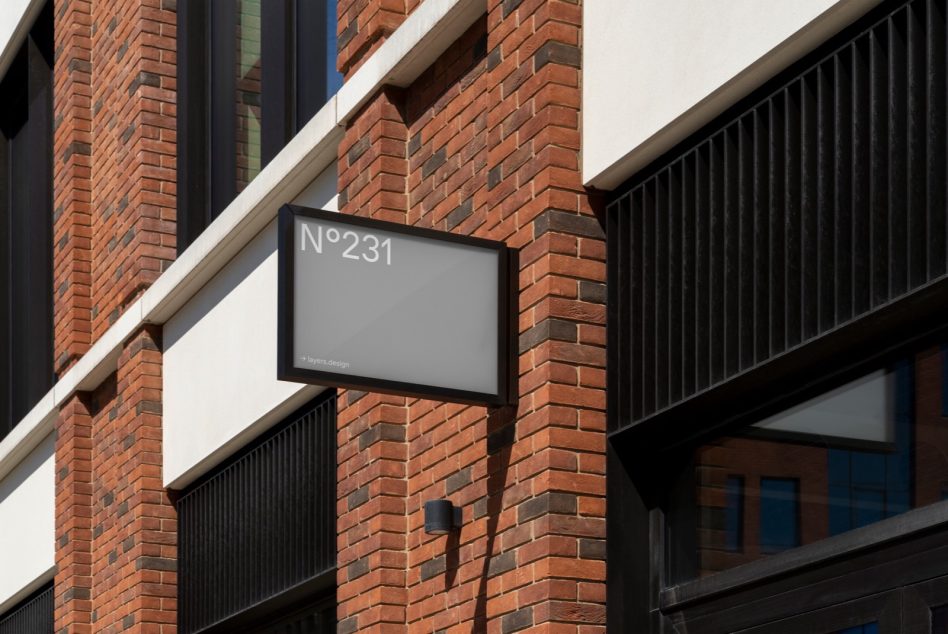 Modern building signage mockup on brick wall exterior for designers, showcasing signage templates, architectural mockups, urban design graphics.