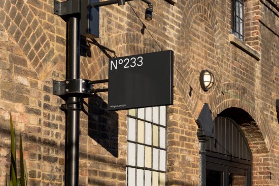 Stylish street number sign mockup on brick wall background, ideal for showcasing address font and signage designs for urban settings.