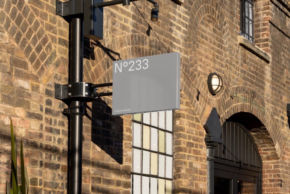 Outdoor signage mockup on lamp post with clear sky, ideal for storefront branding graphics and advertising design presentation.