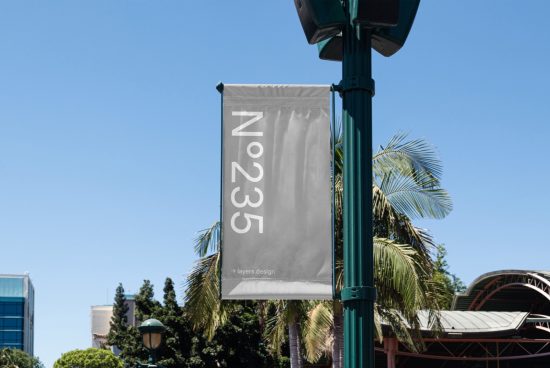 Lamp post banner mockup with modern font design in urban setting ideal for designers looking to display branding graphics and templates.