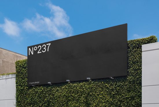 Modern outdoor billboard mockup for advertising designs set against a blue sky and green foliage, perfect for designers' presentations.